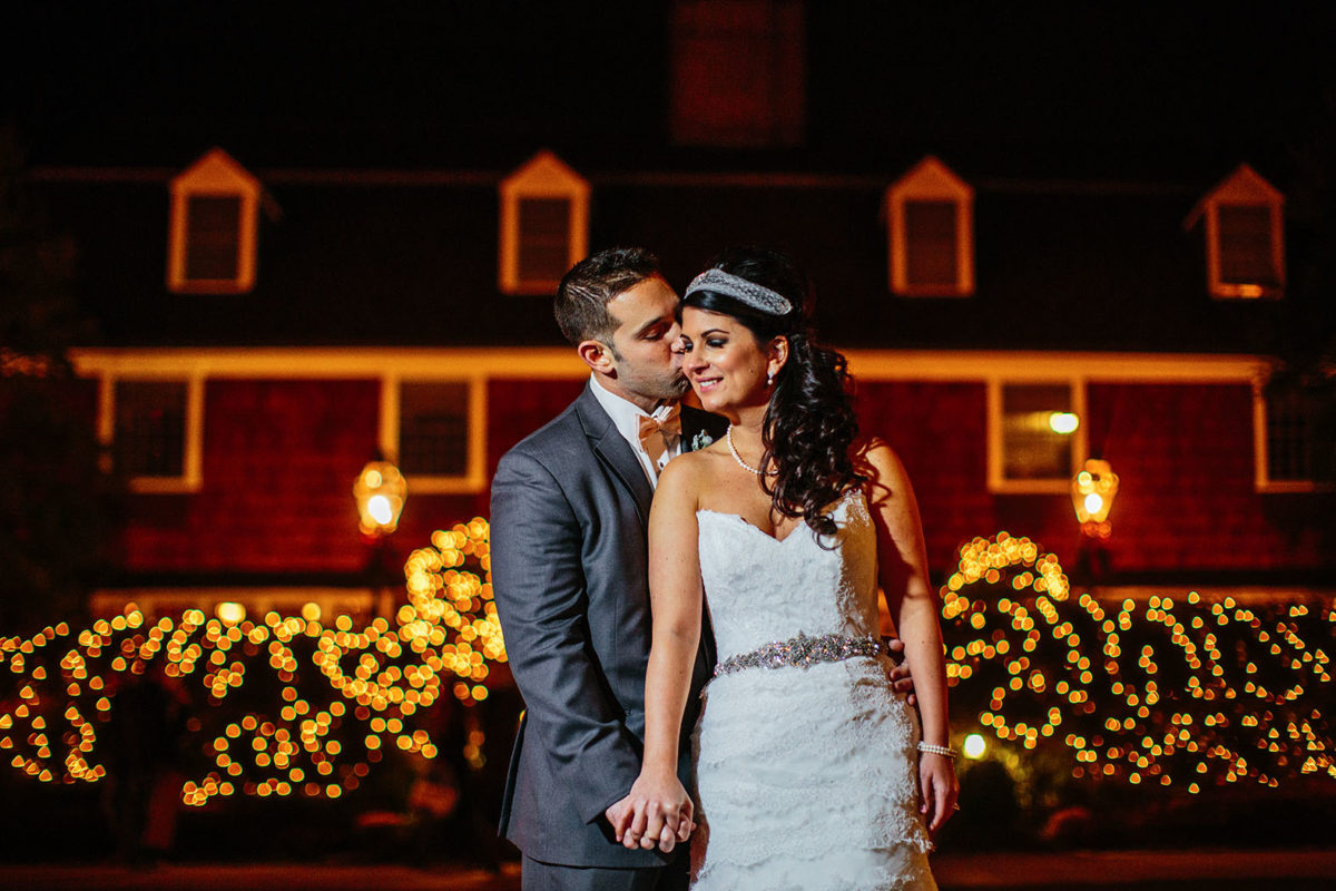 bride and groom posing at night in front of Nassau Inn hotel