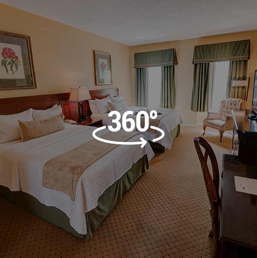 two beds in guest room overlaid with 360 logo