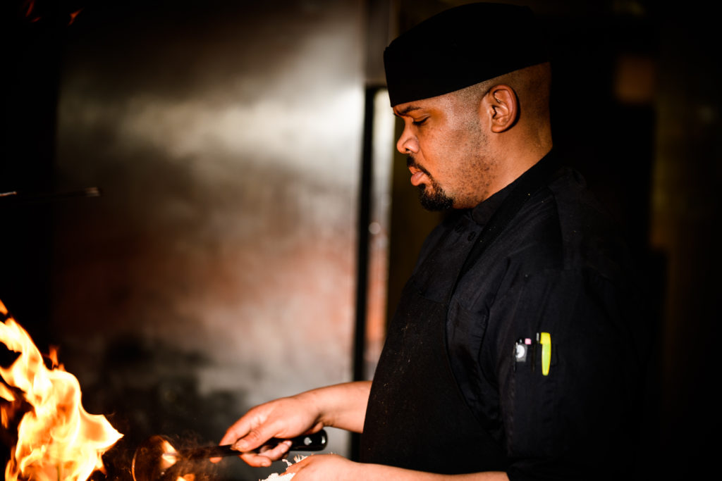 Chef Dontea Johnson cooking in the kitchen.