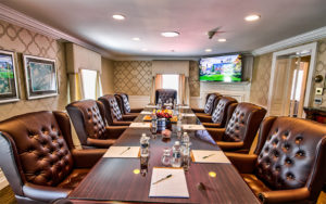 General Mercer Boardroom at the Nassau Inn, with long table, leather chairs, tv and windows overlooking Palmer Squar