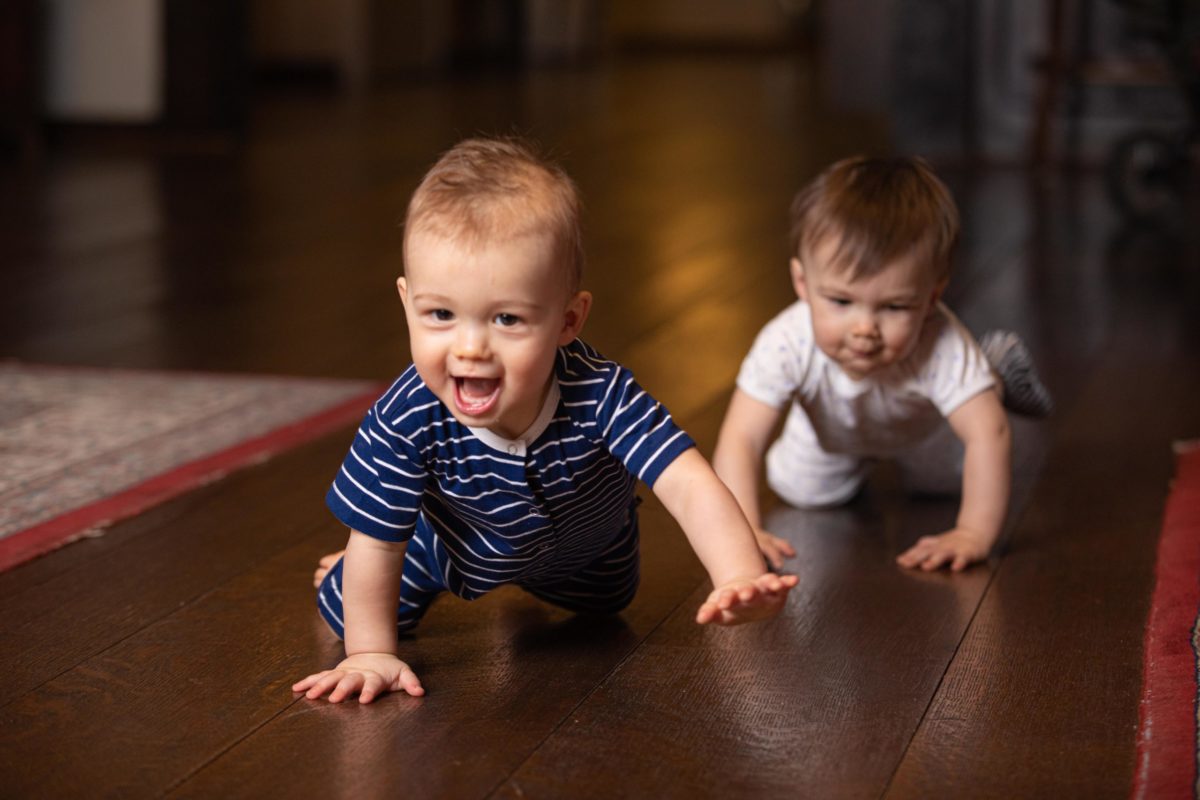 two babies crawling and smiling