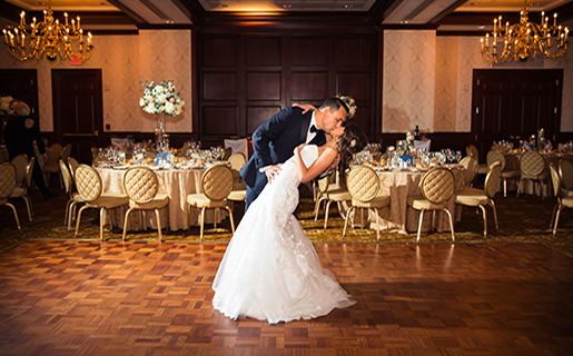 bride and groom kissing on the ballroom dance floor