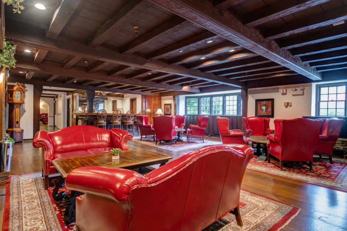 red leather couches and chairs by fireplace