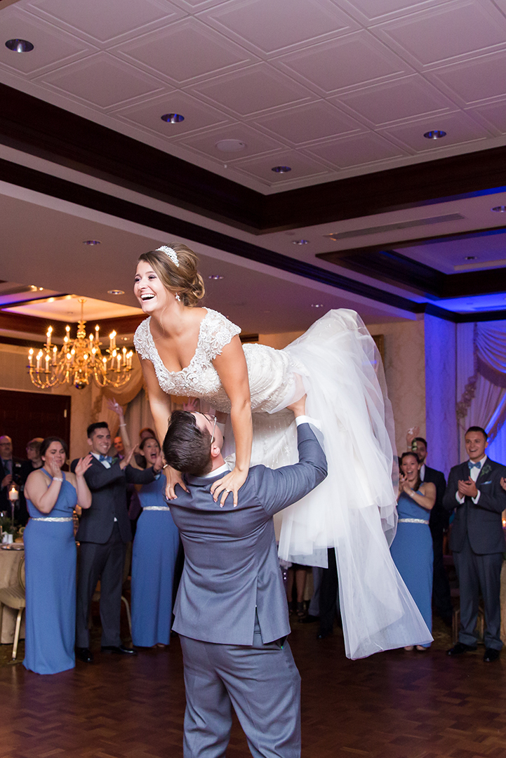 groom lifting bride in the air