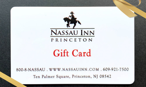 Nassau Inn gift card with gold ribbon and black background
