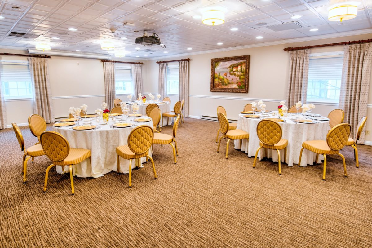 banquet room with three tables set with chairs
