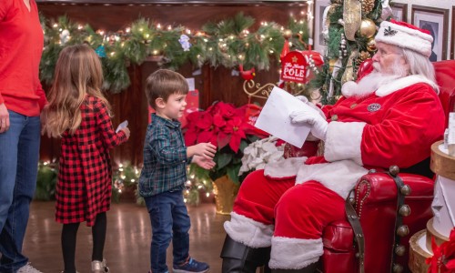 santa reading letters with children