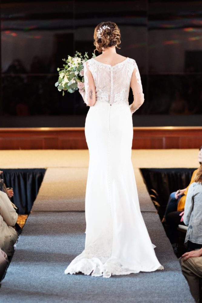 woman modeling bridal gown on runway