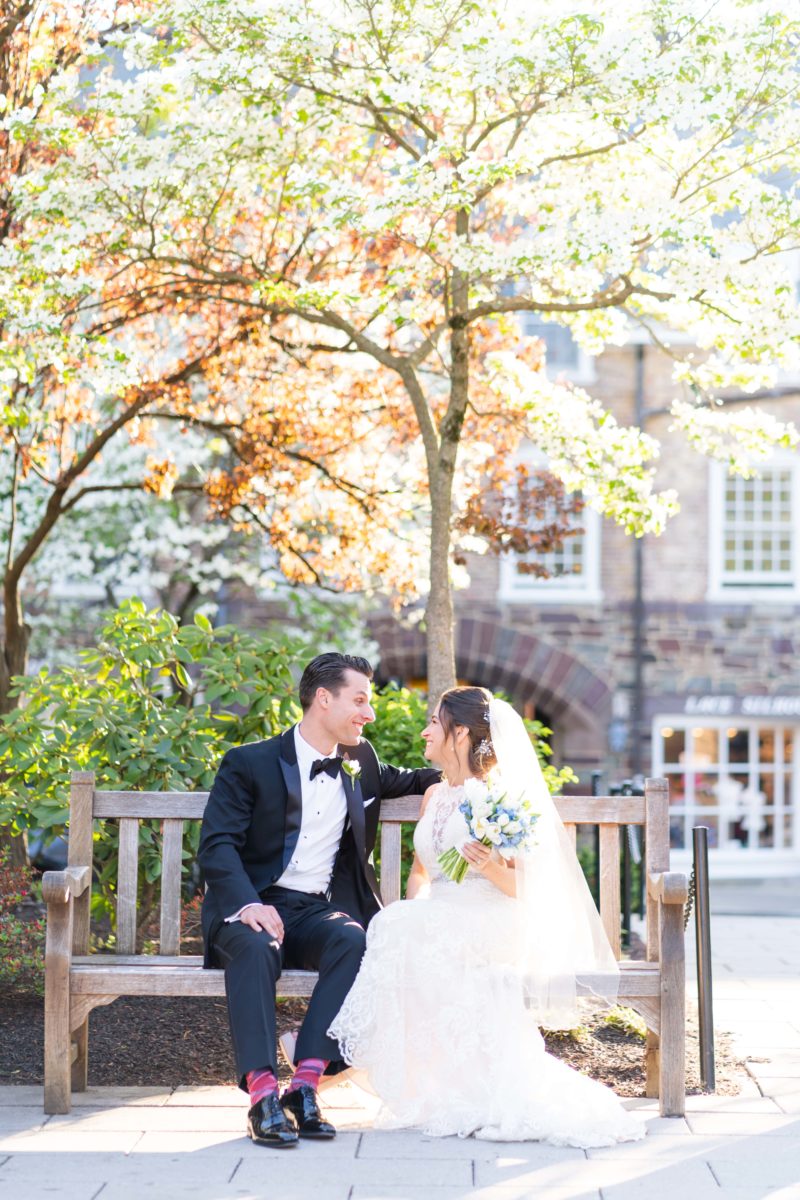 bride and groom sitting on bench outside