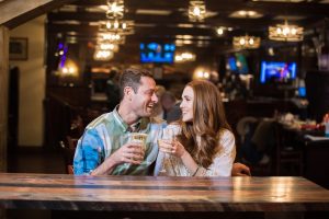 A couple sitting at a bar enjoying a drink together at the Yankee Doodle Tap Room restaurant in Princeton, NJ