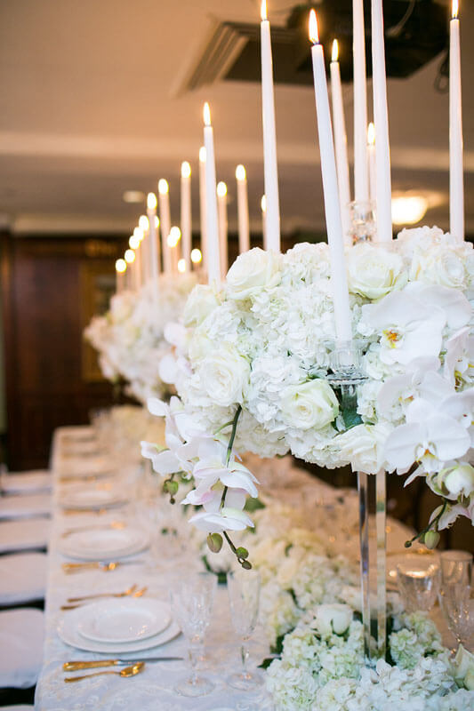 runner of centerpiece flowers and candles