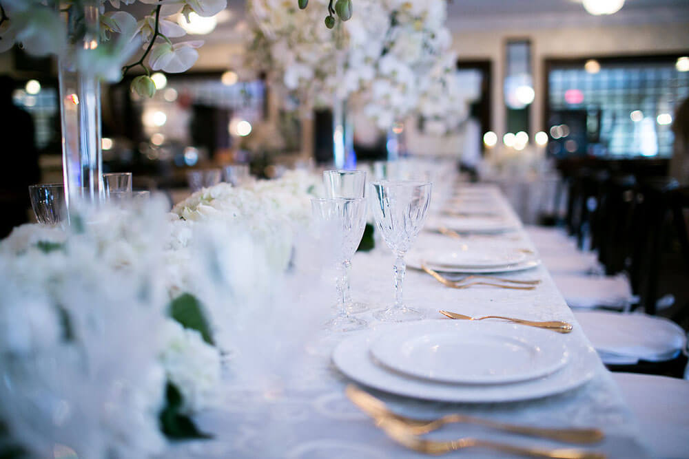 long table with wedding setting and centerpieces