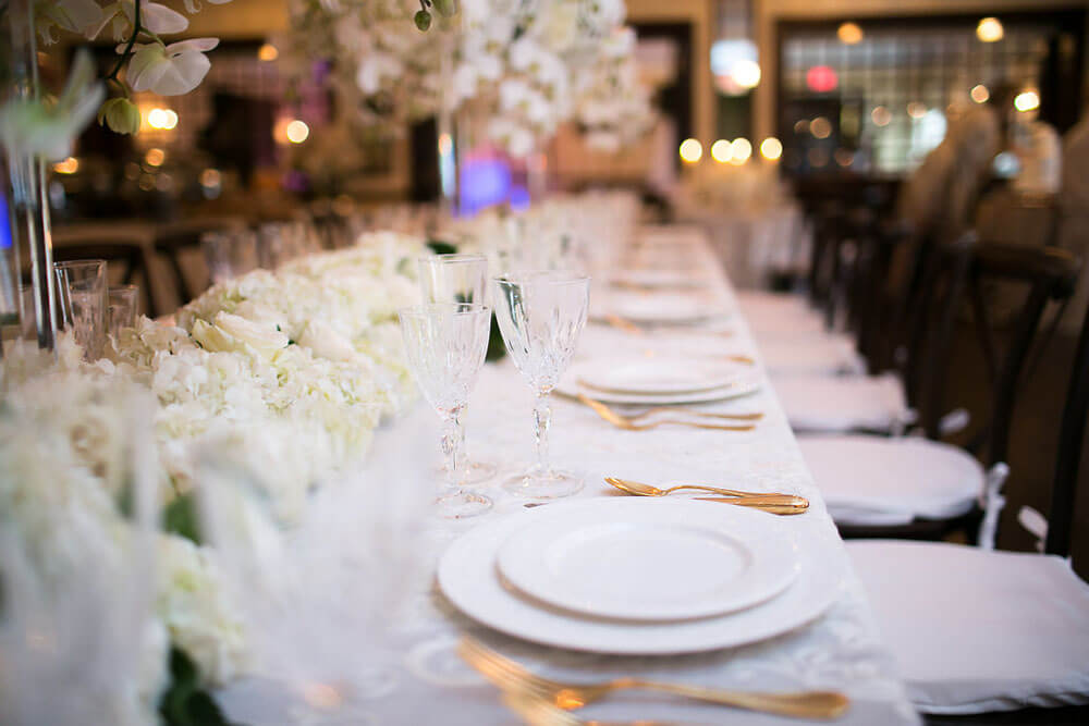 long table with wedding setting and centerpieces