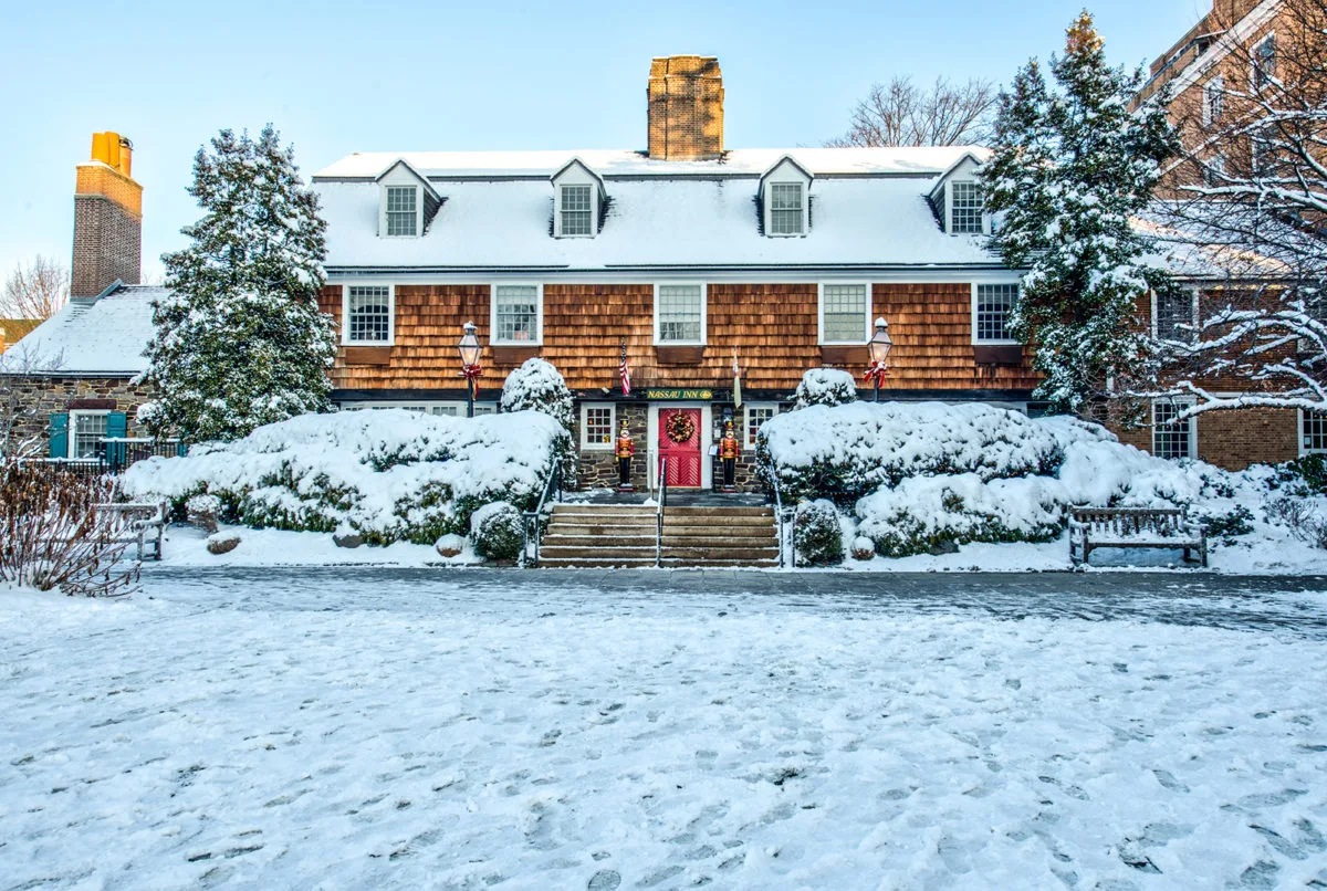 snowy exterior of nassau inn hotel red door
