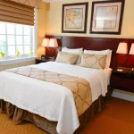 hotel room bed with lamps on each side