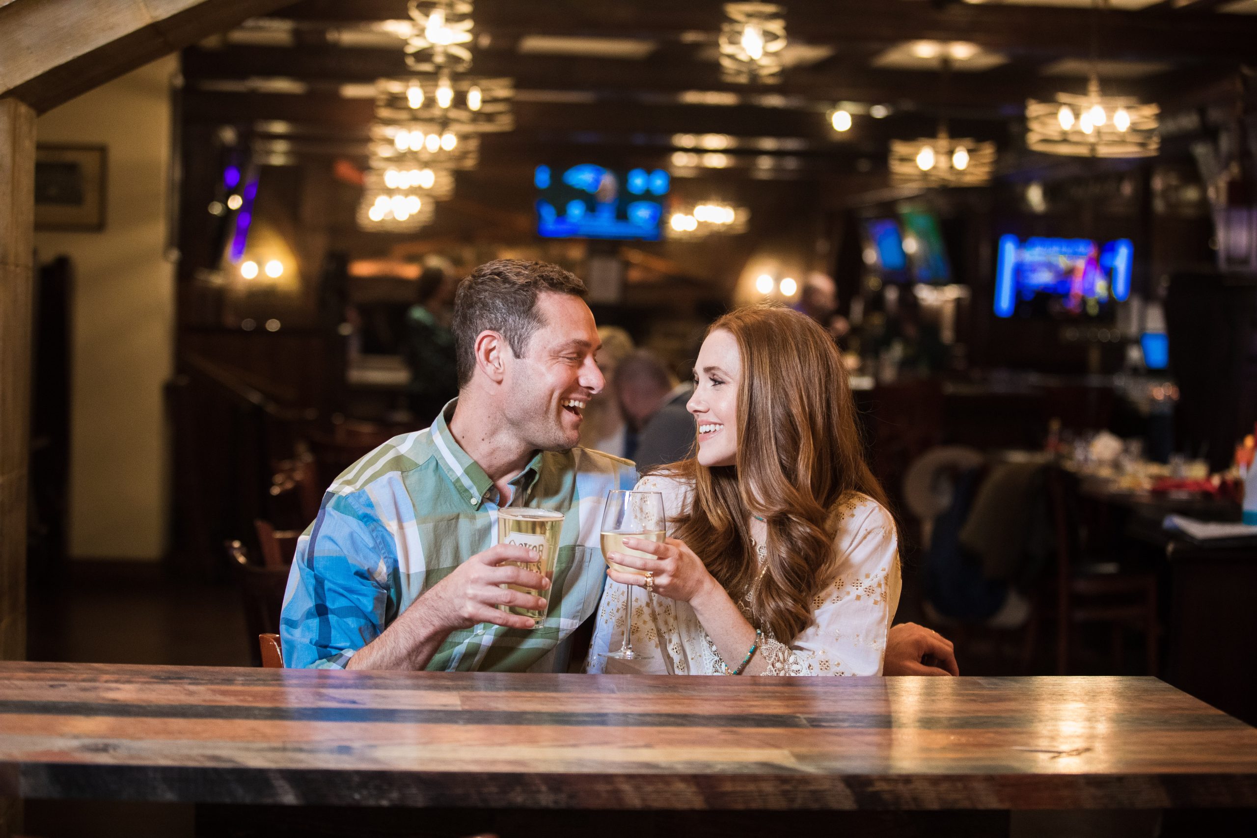 A couple sitting at a bar enjoying a drink together at the Yankee Doodle Tap Room restaurant in Princeton, NJ