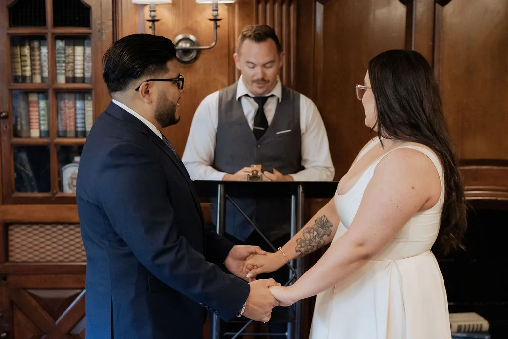 micro wedding ceremony in the library room