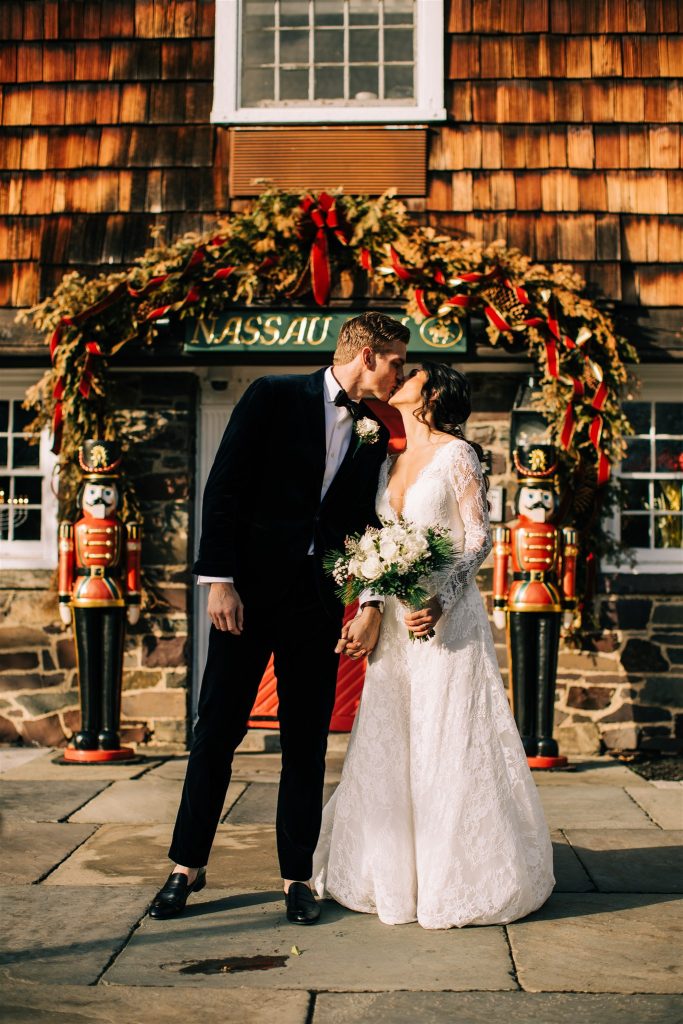 Couple portrait by the red door with Christmas decor 