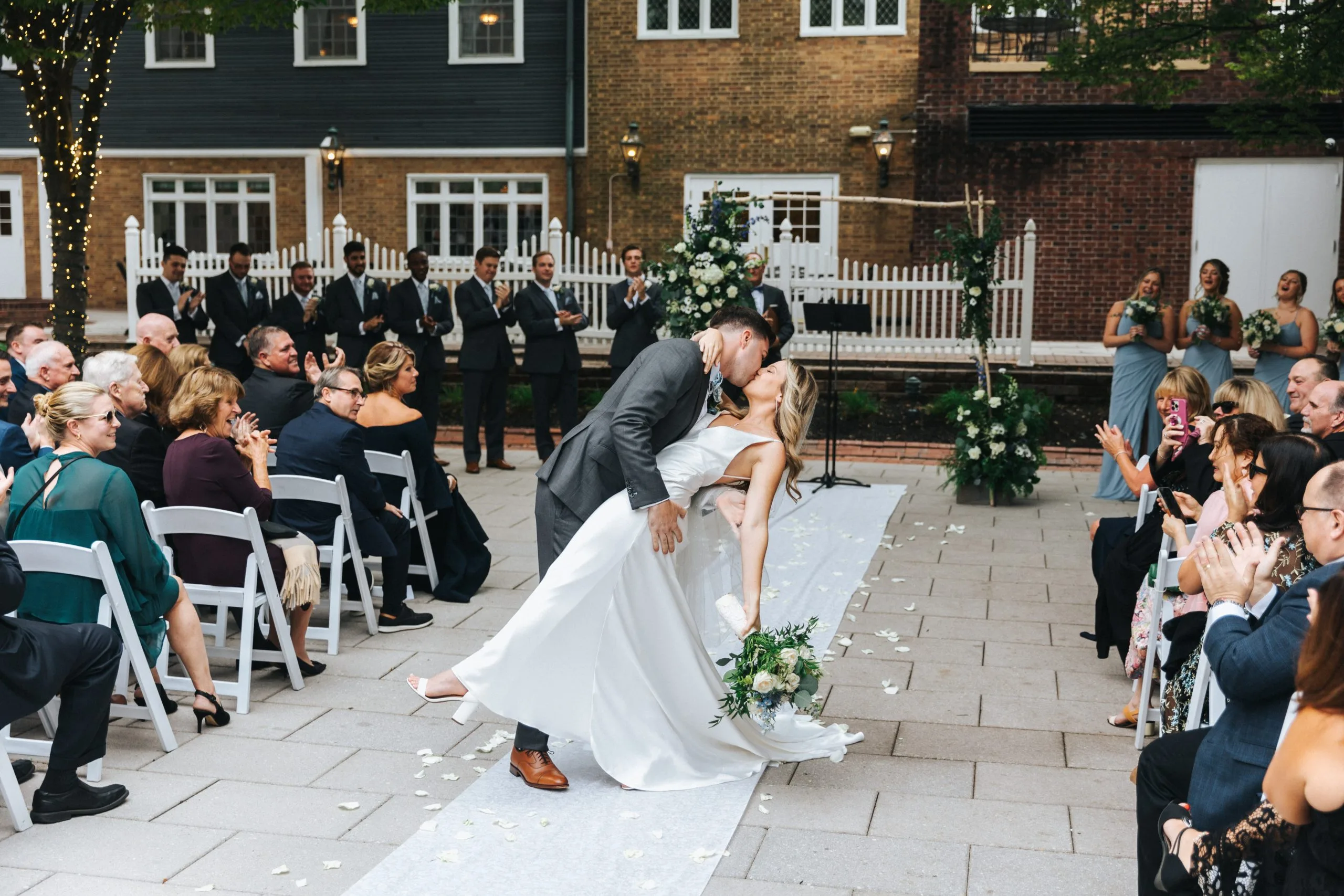 A groom 'dips' his bride for a kiss after their wedding at the historic Nassau Inn in Princeton, NJ.
