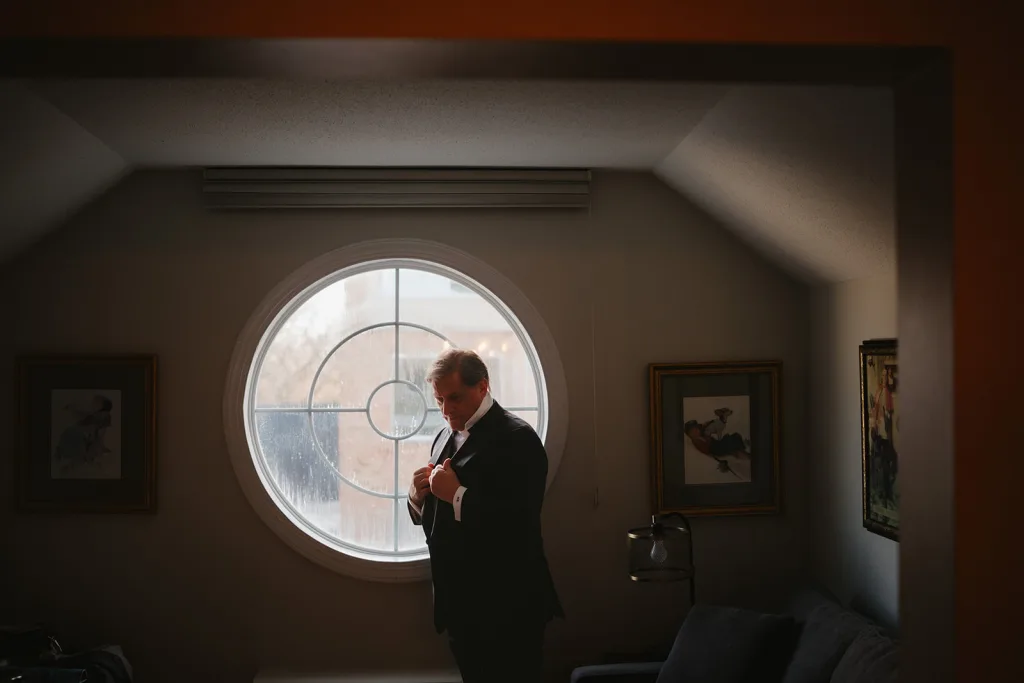 Groom getting ready in Rockwell Suite